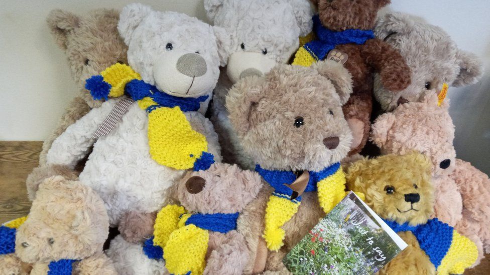 Teddy bears in blue and yellow scarves