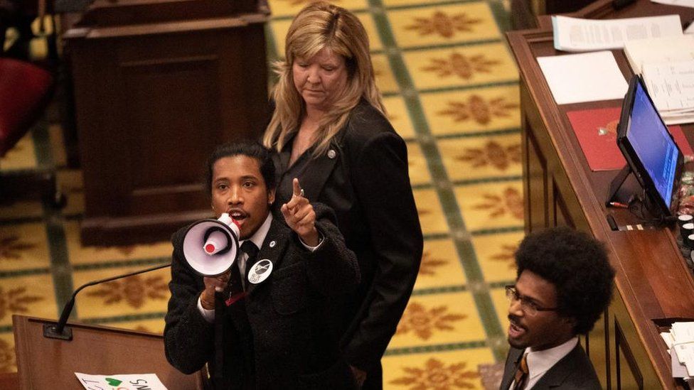 Tennessee State Representative Justin Jones, standing with Rep. Justin Pearson and Rep. Gloria Johnson, calls on his colleagues to pass gun control legislation from the well of the House Chambers during the legislative session, three days after the mass shooting at The Covenant School, at the State Capitol in Nashville, Tennessee, U.S. March 30, 2023.