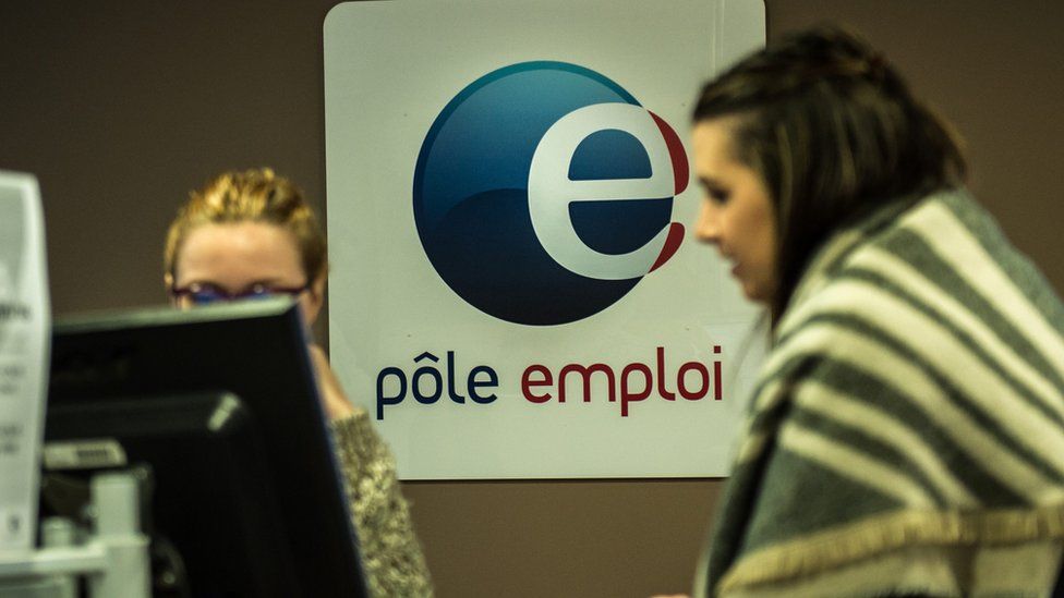 An employee of Pole Emploi, French national employment, agency speaks with an unemployed woman at an agency in Lille, northern France, in December 2015.