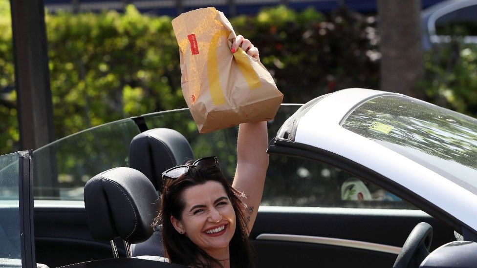 Woman brandishes McDonald's bag