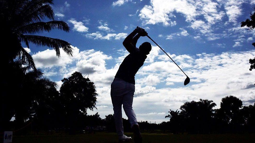 Silhouetted golf player in Thailand