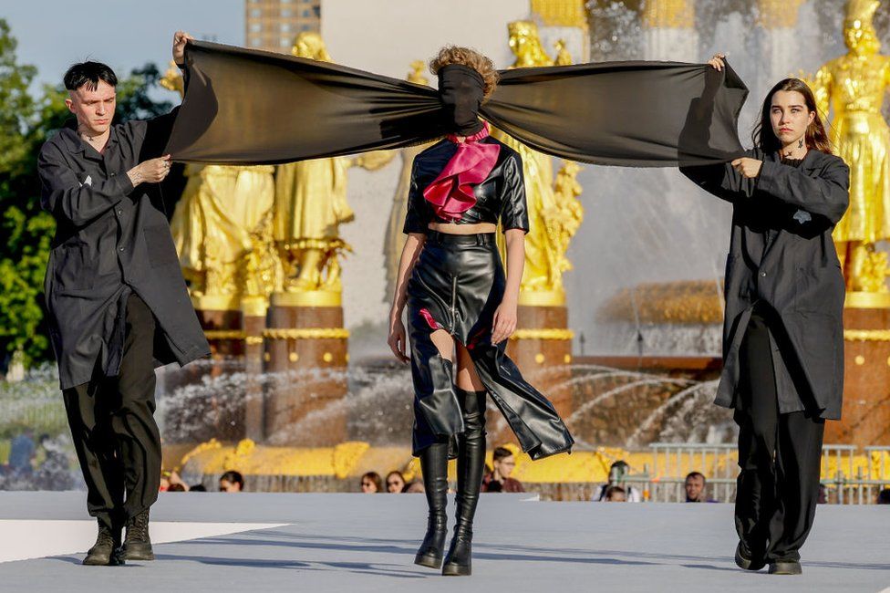 Models present the creation by Denis Detalov during Moscow Fashion Week at VDNHa Park in Moscow, Russia on June 23, 2022