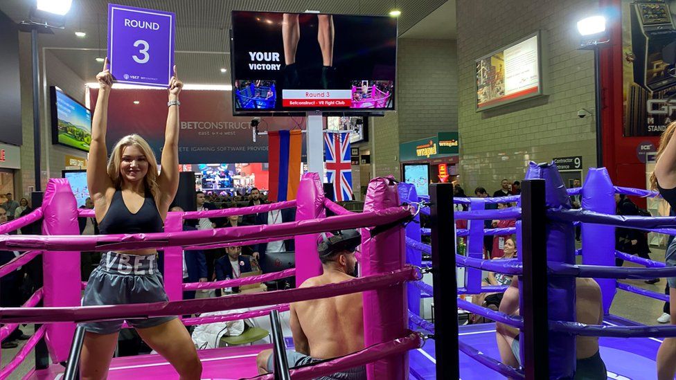 A "ring girl" promotes a betting firm