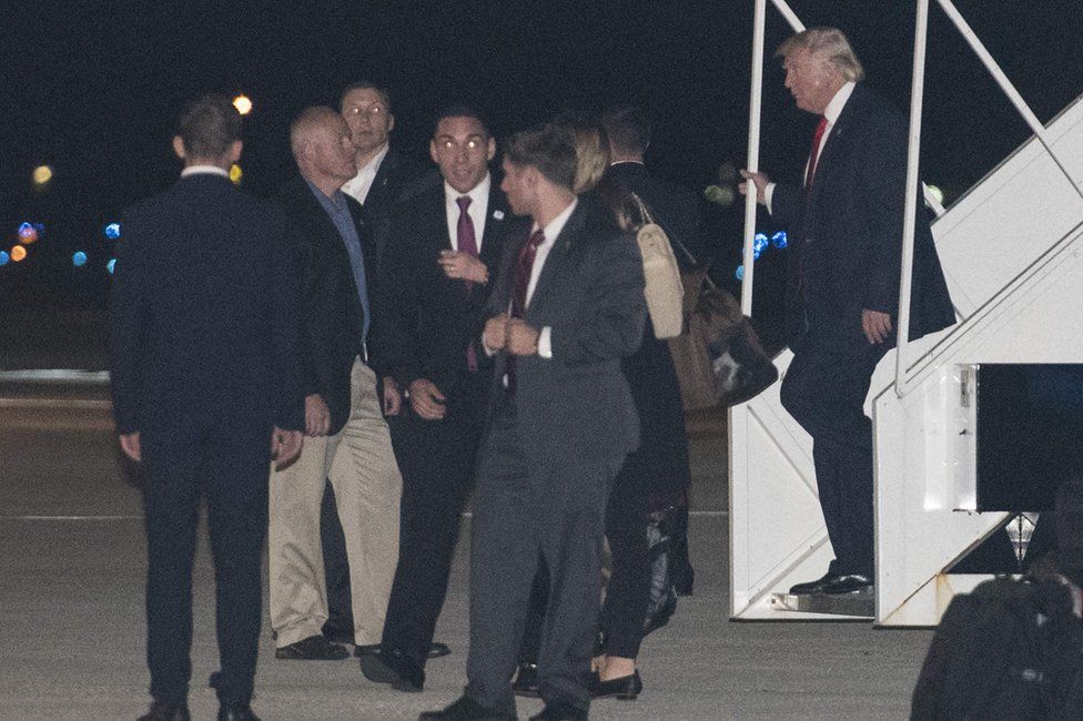 US President-elect Donald Trump (R) steps off his plane upon arrival at Palm Beach International Airport in West Palm Beach, Florida, 22 November