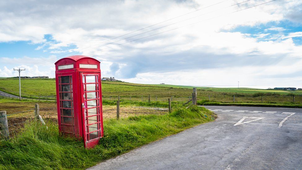 A phone box at the side of a road