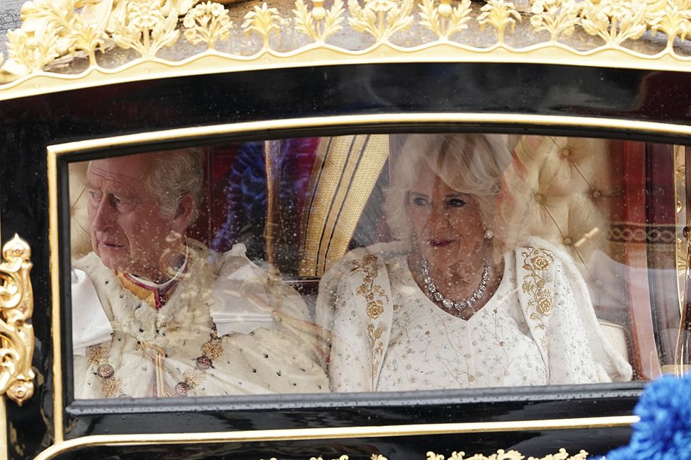King Charles III and Queen Camilla are carried in the Diamond Jubilee State Coach