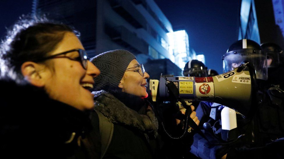 Protesters outside state TV denounced the new overtime law as a "slave law" on Monday night