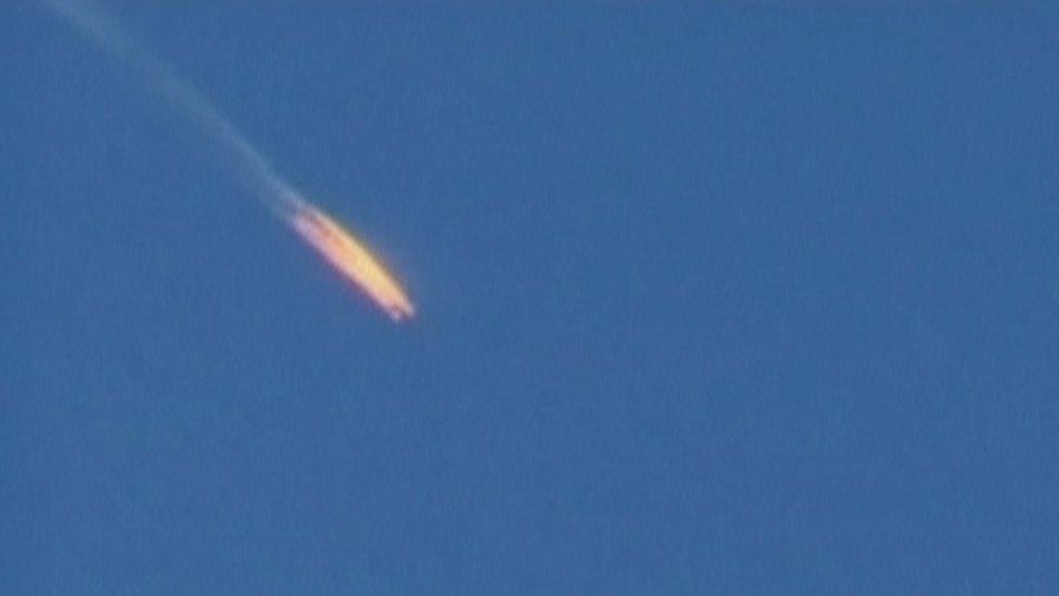 A screengrab image of a Russian plane crashing after being shot down by Turkish forces