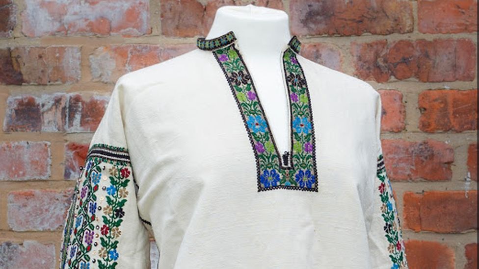 A tunic with colourful embroidery around the neckline and on the sleeves