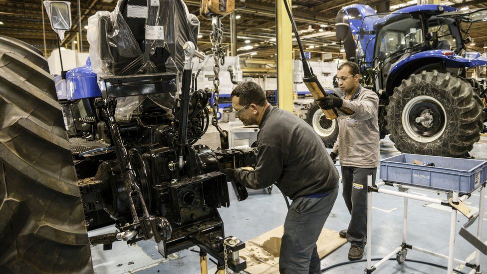 Workers assemble New Holland tractors in Curitiba