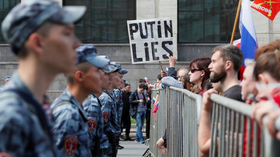 Russia's National Guard watch protesters during the rally