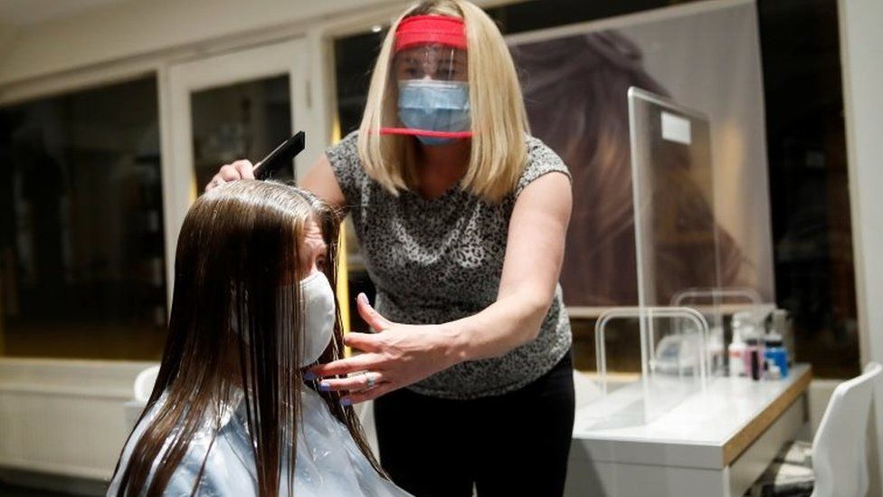 Kelly Boad, owner of Hair and Beauty Gallery in Warwick, gives Sue Butcher a haircut as non-essential businesses reopen as coronavirus disease