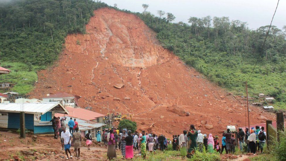 People inspect the damage after mudslides in the mountain town of Regent near Freetown, 14 August 2017