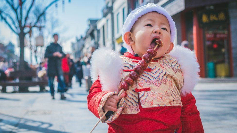 A small boy in traditional outfit for Chinese New Year in Beijing.