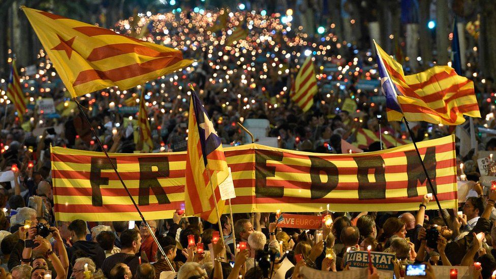 People attend a candle-lit demonstration in Barcelona against the arrest of two Catalan separatist leaders on October 17, 2017