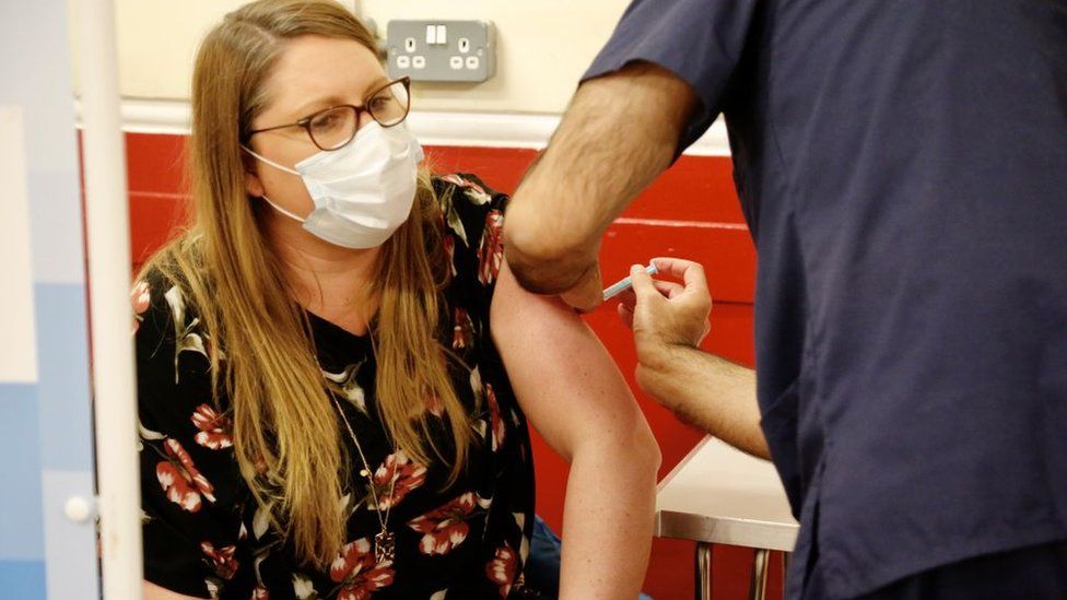 Woman being vaccinated in London