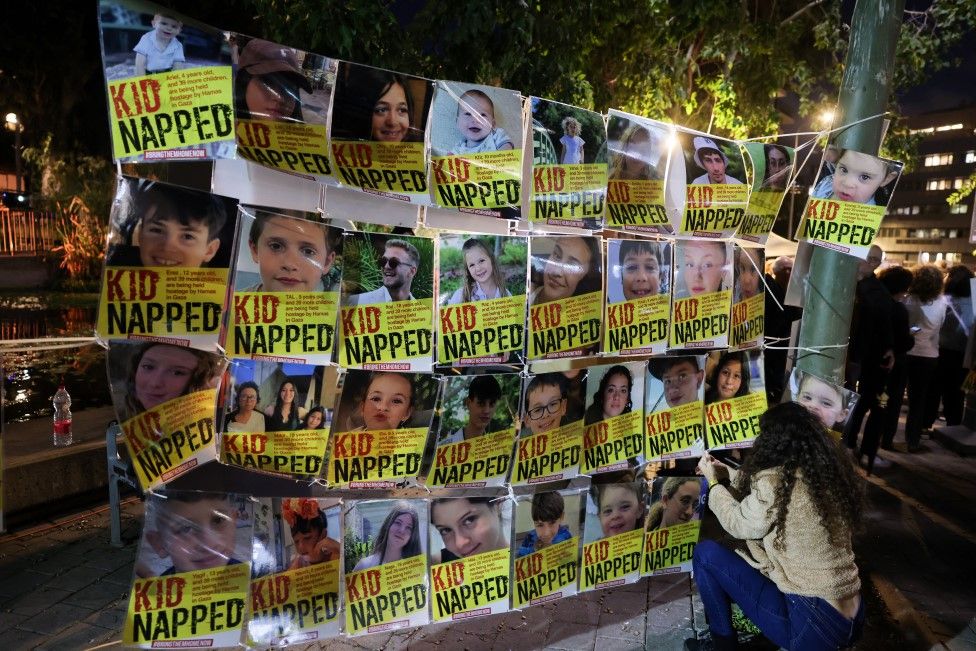 Portraits of Israeli children hostages displayed at a rally in Tel Aviv