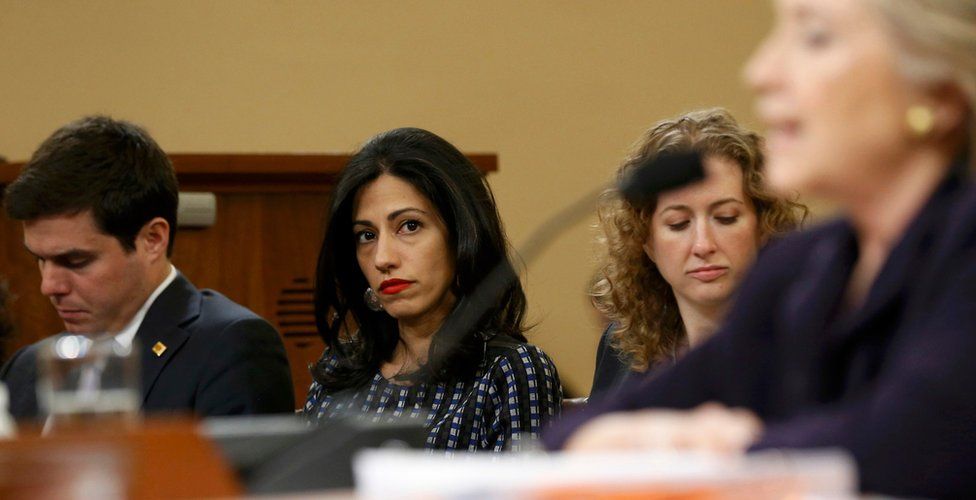 Hillary Clinton"s advisors Nick Merrill (L), Huma Abedin (C) and an unidentified staff member (2nd R) listen as the former secretary of state testifies before the House Select Committee on Benghazi, on Capitol Hill in Washington October 22, 2015.