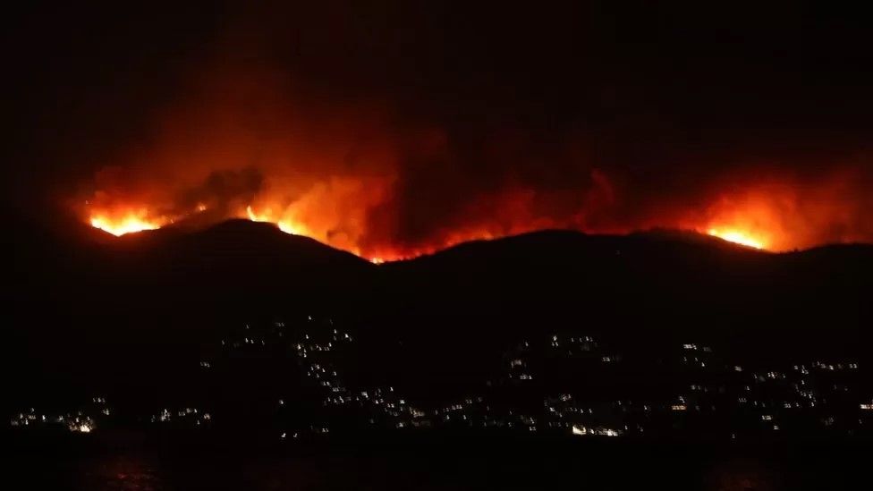 flames engulfing a ridgeline in Corfu