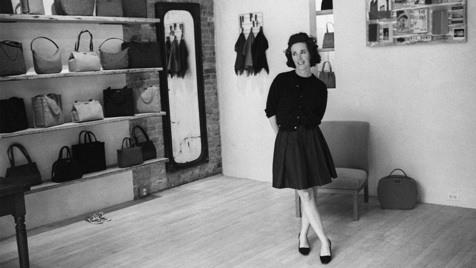 Kate Spade in her first handbag shop in black and white photograph from 1996