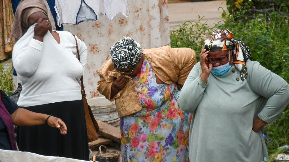 Women crying outside destroyed church