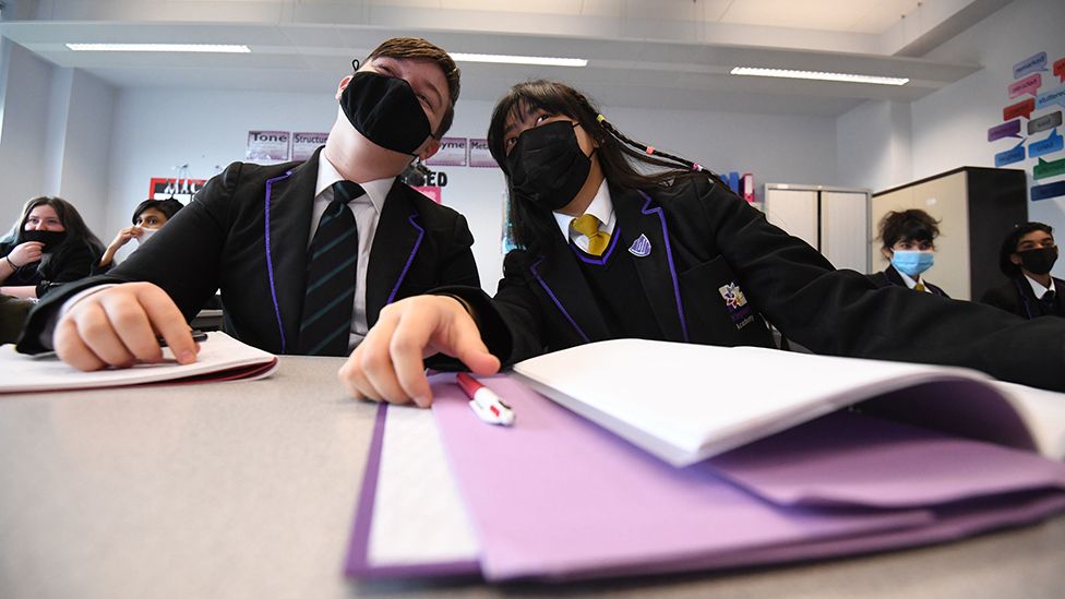 Children wearing facemasks during a lesson at Hounslow Kingsley Academy in West London on 8 March, as pupils in England return to school for the first time in two months as part of the first stage of lockdown easing