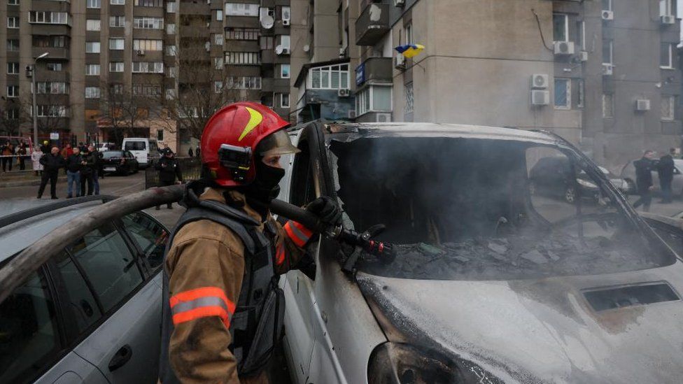 Emergency workers extinguish fire in vehicles at the site of a Russian missile strike, amid Russia's attack on Ukraine, in Kyiv, Ukraine March 9, 2023