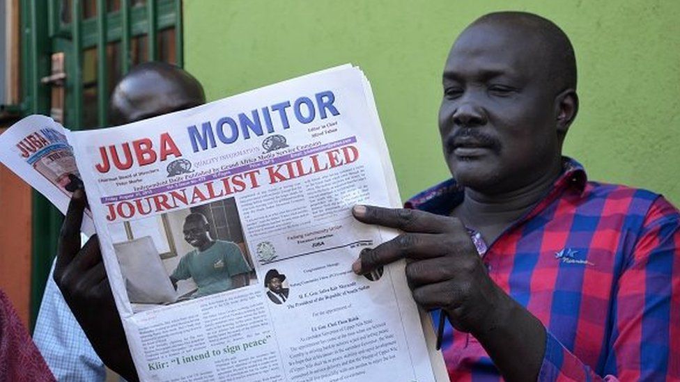 A man reads a copy of the Juba Monitor, with a heading referring to the killing of South Sudanese journalist Peter Moi of The New Nation newspaper, on August 21, 2015 in Juba.
