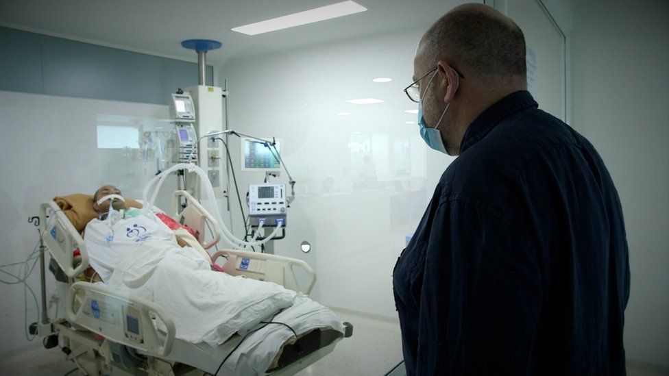 John Sweeney visits a paralysed patient in hospital