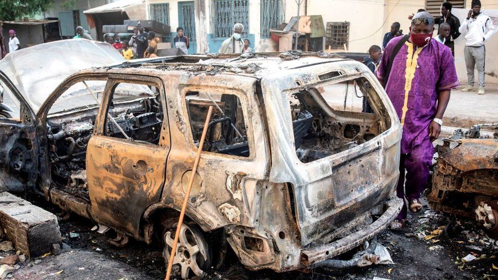 Cars were burnt near the headquarters of a radio station thought to be close to Senegal's government