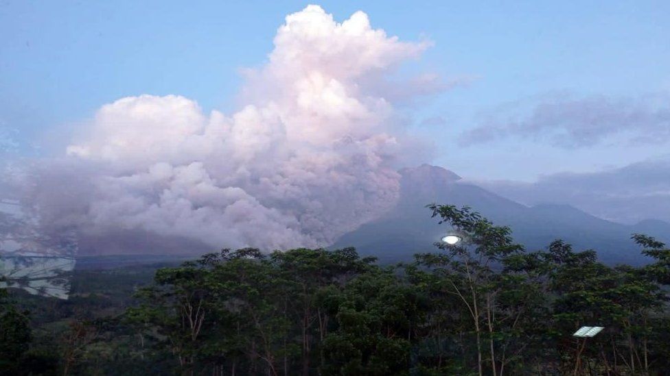 Volcanic materials from Mount Semeru rising in the sky