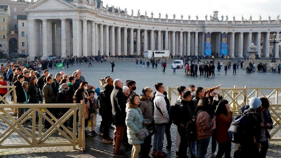 People queue to enter St. Peter's Basilica, the day after the announcement of the worsening condition of former Pope Benedict's health, at the Vatican, December 29, 2022.