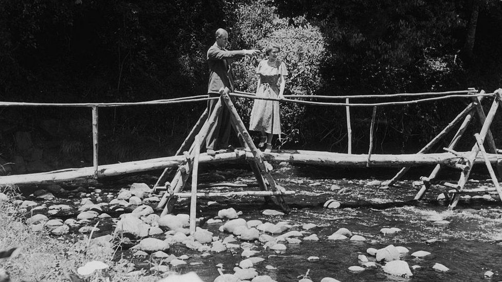 Princess Elizabeth and the Duke of Edinburgh admiring the view from a bridge in the grounds of Sagana Lodge, their wedding present from the people of Kenya. 5 February 1952: