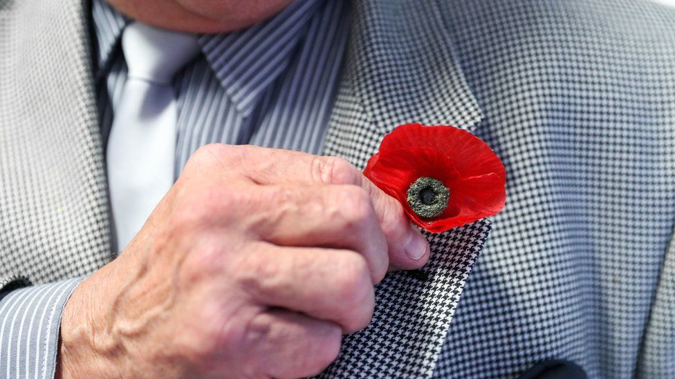 Bernie Axtell, 77, wears a poppy believed to date back to before World War Two