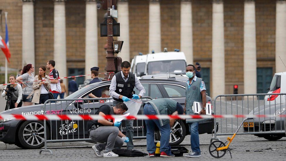 French police look for clues after a car drove through barriers set up for the final stage of the Tour de France in central Paris, France, July 26, 2015.