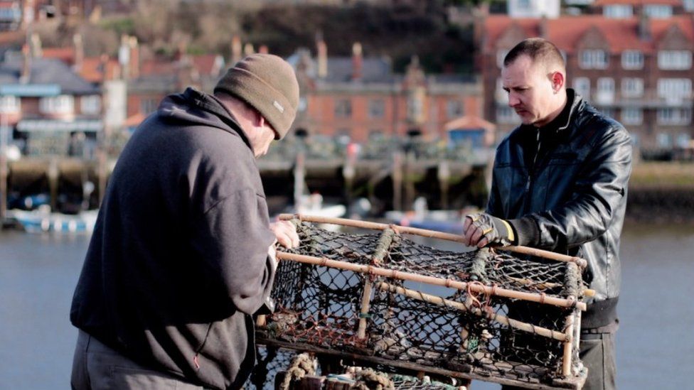 Fishermen with lobster pot