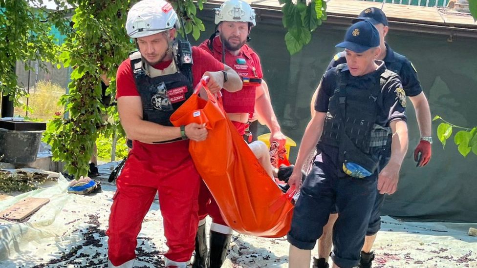 Volunteers and rescue workers evacuate people in the Kherson region