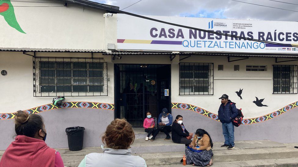 People wait outside a shelter for unaccompanied minors in Quetzaltenango, Guatemala