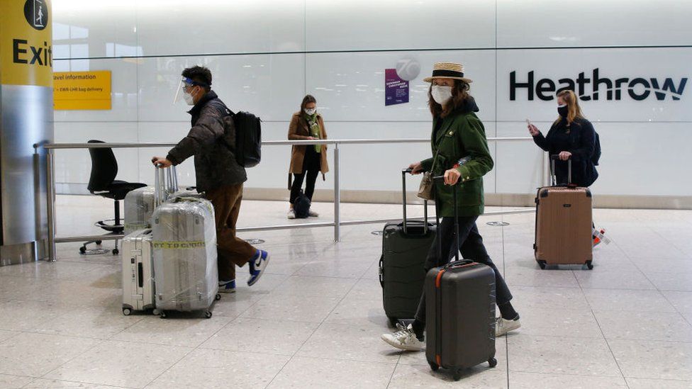 Travelers arrive at Heathrow Terminal 2