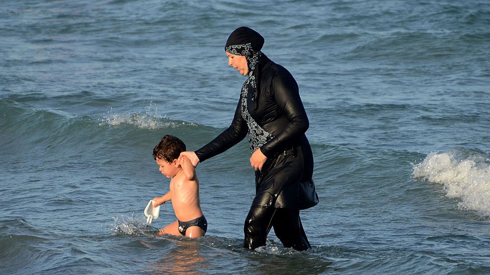 Woman wearing a burkini in the sea