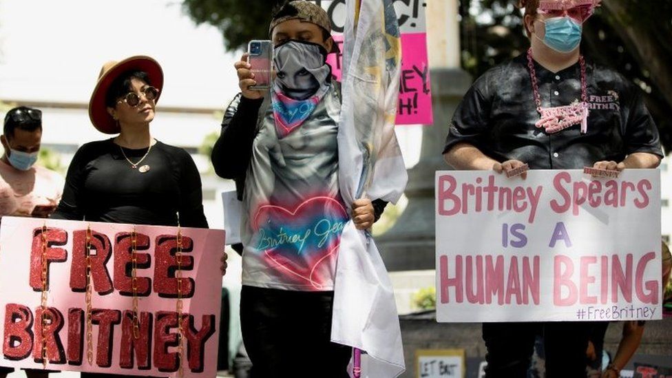 Fans holding 'Free Britney' and 'Britney Spears is a human being' signs outside court