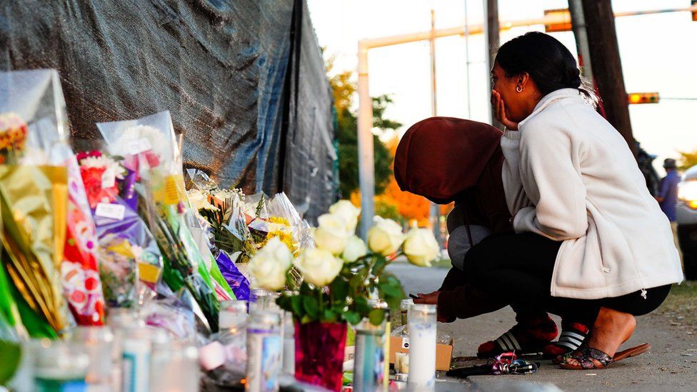 Visitors look at the memorial outside of the cancelled Astroworld festival at NRG Park