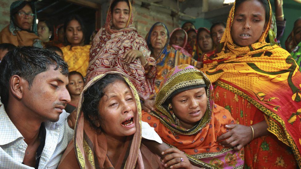 Relatives of people killed as unidentified gunmen attacked a mosque during evening prayers on Thursday, grieve before their funeral in Bangladesh's Bogra district, Friday, 27 November 2015