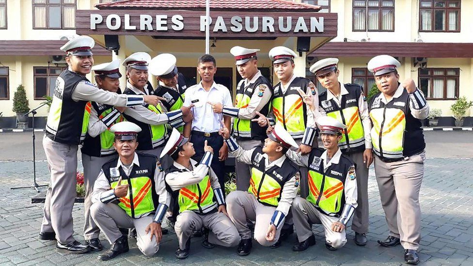 Mr Polisi and his new colleagues outside the Pasuruan police house