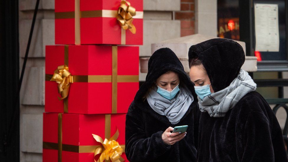 Two women looking at a phone in Covent Garden