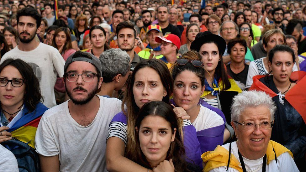 Image shows Pro-independence supporters reacting to Carles Puigdemont's speech in Barcelona
