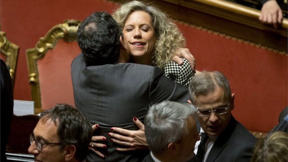 Italian senators hug after Thursday's vote