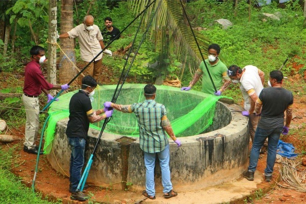 Animal Husbandry department and Forest officials inspect a well to to catch bats at Changaroth in Kozhikode in the Indian state of Kerala on May 21, 2018.