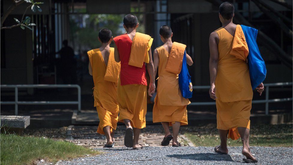 Buddhist monks enter the Wat Dhammakaya temple grounds, north of Bangkok, 1 March 2017