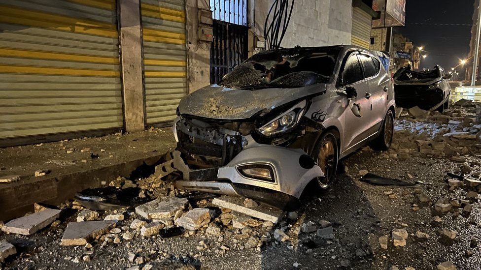 A car damaged by rubble
